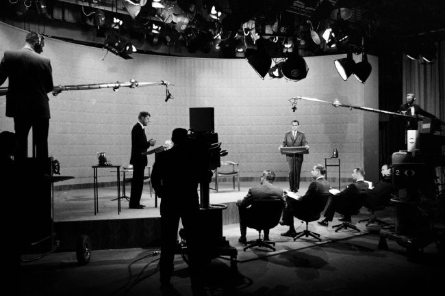FILE - In this Oct. 21, 1960 file photo, Democratic presidential candidate, Sen. John F. Kennedy, center left, and Republican candidate, Vice President Richard Nixon, stand in a television studio during their presidential debate in New York. Polls found those who listened on radio awarded Nixon the debate victory. Those watching on TV gave Kennedy the nod. (AP Photo)